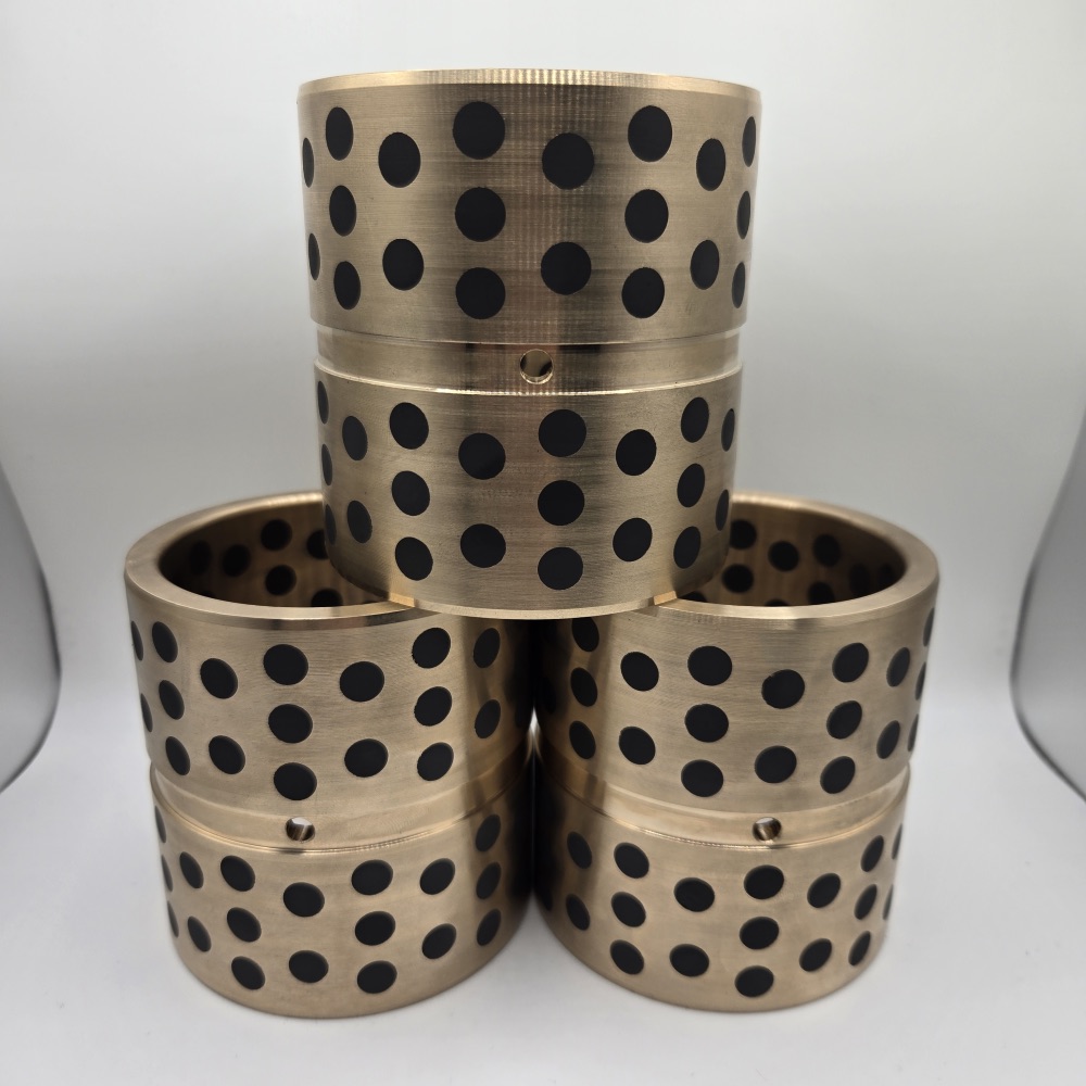 Set of graphite-plugged bronze bushings